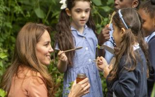 The Duchess of Cambridge gives children some honey from her Norfolk home to try during her visit to the Natural History Museum
